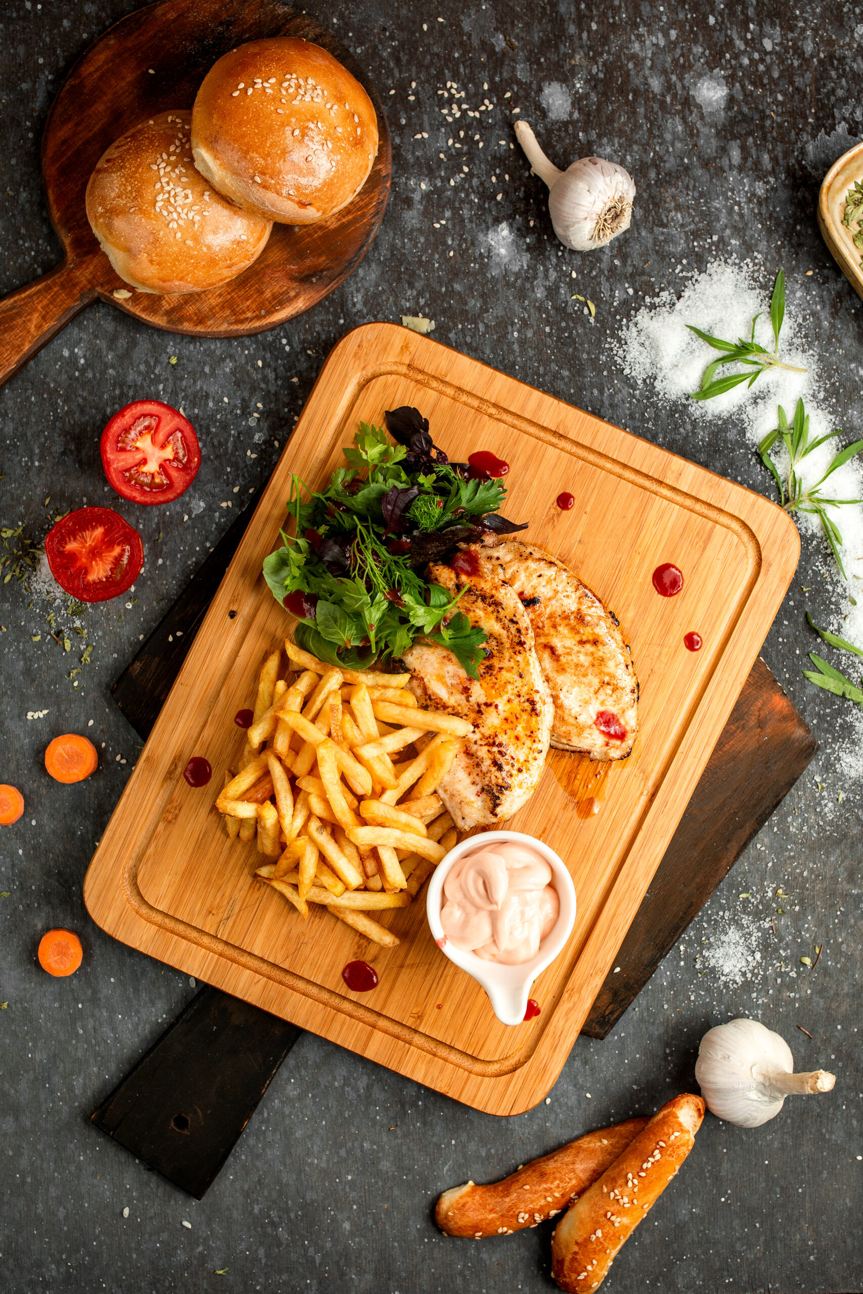 chicken chop and french fries on a wooden board